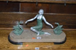 AN ART DECO STYLE FIGURE OF A LADY, and two swans on a marble base