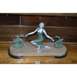 AN ART DECO STYLE FIGURE OF A LADY, and two swans on a marble base