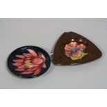 TWO PIECES MOORCROFT POTTERY, to include 'Hibiscus' triangular ash tray on brown ground, impressed
