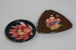 TWO PIECES MOORCROFT POTTERY, to include 'Hibiscus' triangular ash tray on brown ground, impressed