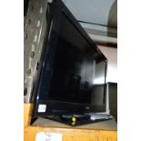 A SONY KDL 32CX 32' LCD TV, (remote) and a black glass TV stand (2)