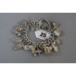 A SILVER CHARM BRACELET, approximate weight 123.7 grams