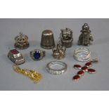 A BAG OF MISCELLANEOUS SILVER CHARMS, etc, including an enamel cross