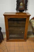 A VICTORIAN WALNUT GLAZED SINGLE DOOR BOOKCASE (key)