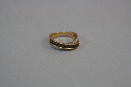 A MODERN 18CT GOLD DIAMOND AND SMOKY QUARTZ CROSSOVER STYLE ETERNITY RING, estimated total modern