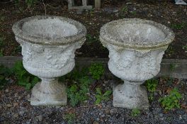 A PAIR OF PRE CAST GARDEN URNS, on seperate base, approximate height 69cm x depth 58cm