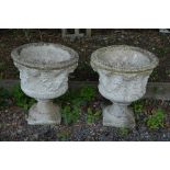 A PAIR OF PRE CAST GARDEN URNS, on seperate base, approximate height 69cm x depth 58cm