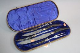 A LATE VICTORIAN CASED HORN HANDLED CARVING SET, for meat and game, with steel, silver band,