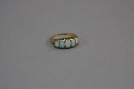 AN EARLY 20TH CENTURY 18CT GOLD FIVE STONE GRADUATED OPAL HALF HOOP RING, white opals with a