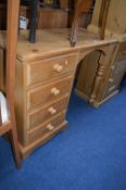 A PINE DESK WITH FOUR DRAWERS