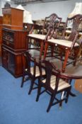 A MODERN MAHOGANY EXTENDING DINING TABLE, six chairs including two carvers, matching wall unit, hi-