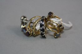 A MIXED LOT OF SEVEN 9CT YELLOW METAL AND SILVER RINGS