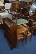 AN OAK BARLEY TWIST DROP LEAF TABLE, two chairs, rocking chair, an oak open bookcase, two rugs,