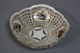 A LATE 19TH CENTURY BERLIN PORCELAIN PIERCED BOWL, the exterior with vignettes of floral sprays