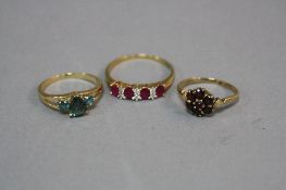 THREE LATE 20TH CENTURY 9CT GOLD DRESS RINGS, to include a green sapphire three stone, a ruby and