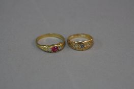 TWO EARLY 20TH CENTURY DRESS RINGS, an 18ct gold three stone diamond and synthetic ruby ring, two