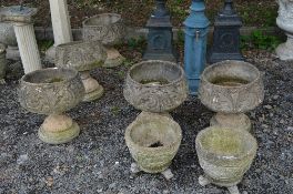 FIVE PRE-CAST GARDEN URNS ON SEPERATE BASES (three urns broken at support) and two other planters (