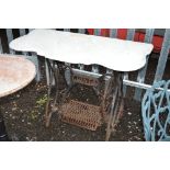 A JONES TREADLE SEWING MACHINE STAND, with white marble top