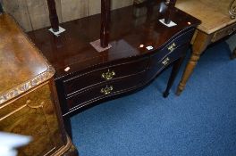 A MODERN MAHOGANY SERPENTINE HALL TABLE, with four drawers