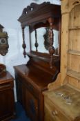 AN EDWARDIAN WALNUT MIRROR BACK SIDEBOARD, with two drawers and a pair of carved panel doors,