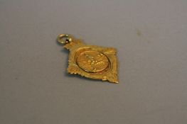 A 9CT FOOTBALL FOB, approximate weight 5.3 grams