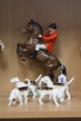 A BESWICK HUNTSMAN on rearing horse No.868 (style one second version), together with four fox