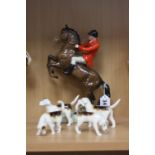 A BESWICK HUNTSMAN on rearing horse No.868 (style one second version), together with four fox