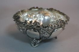 A GREEK SILVER EMBOSSED DISH, with vine leaf decoration to the top, impressed 'EPT XEIPOE',