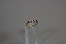 A 9CT RUBY AND DIAMOND SEVEN STONE RING, ring size R, approximate weight 2.1 grams