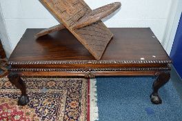 A CARVED HARDWOOD COFFEE TABLE, on ball and claw feet