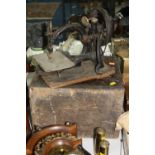 A WILCOX AND GIBBS S M CO TABLE TOP SEWING MACHINE, with a wooden box, in need of attention