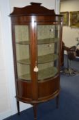 AN EDWARDIAN MAHOGANY AND INLAID DEMI LUNE SINGLE DOOR DISPLAY CABINET, with raised back on spade