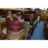 TWO LEATHER STYLE STUFFED FOOTSTOOLS, two various cases and a vintage cardboard case (5)