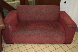 AN UPHOLSTERED TWO SEATER SETTEE