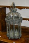 A MODERN OCTAGONAL HANGING LANTERN, with bowed glass and hinged top, approximate height 72cm