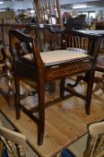 AN EDWARDIAN STYLE PIANO STOOL, with hinged front and raised back and sides