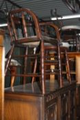 A STAINED OAK SMOKERS ARMCHAIR, and two spindle back chairs (3)
