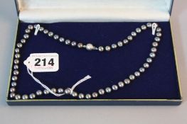 A SET OF BLACK CULTURED PEARL NECKLACE, with 18ct clasp