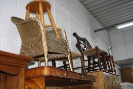 A GOLD PAINTED LLOYD LOOM BEDROOM CHAIR, two oak rush seated chapel chairs, another chair and two