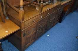 A CARVED OAK SIDEBOARD WITH THREE SMALL DRAWERS, approximate size width 139cm x depth 46cm x 84cm