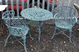 A HEAVY PAINTED CAST IRON CIRCULAR GARDEN TABLE, with under tier and two matching armchairs