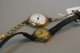 TWO EARLY 20TH CENTURY LADIES WATCHES, a swiss mechanical, white enamel dial with Arabic numerals,