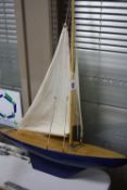 A WOODEN POND YACHT, in need of minor restoration, length approximately 60cm x width 16cm