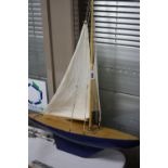A WOODEN POND YACHT, in need of minor restoration, length approximately 60cm x width 16cm