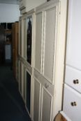 A LARGE FIVE DOOR BEDROOM FITMENT/WARDROBE, matching dressing table, mirror, a bedside chest and a