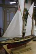 A MODEL OF A SAILING SCHOONER, of wooden construction, in need of minor restoration, length