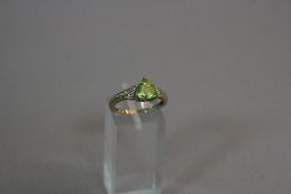 A 9CT PERIDOT AND DIAMOND RING, ring size N, approximate weight 2.6 grams