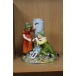 A ROYAL WORCESTER FIGURE GROUP, depicting a boy kneeling down playing a horn, with a young girl