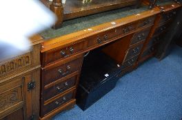 A YEWWOOD PEDESTAL DESK WITH GREEN TOOLED LEATHER INLAY TOP and nine various drawers, approximate