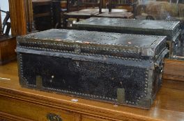 A 19TH CENTURY BRASS AND HIDE TRUNK, with studded brass and banded detail, double drop down